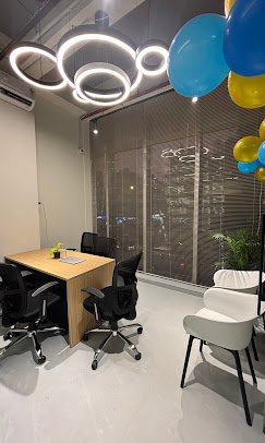 Small meeting room with ring pendant lighting and city-facing blinds