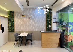 Reception lounge with a living green wall and geometric pendant lights